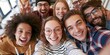 © S-DESIGN - A close-up selfie of a diverse group of young friends laughing and smiling, captured from their perspective, conveying a sense of joy and togetherness