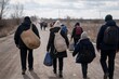 © Dmitry - Refugee family walking along a rural road with backpacks and belongings. Migration, displacement and humanitarian crisis concept.