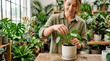 © Pablo - Woman tending to houseplants in a well-lit greenhouse or plant shop.