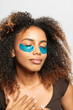 © Gonzalo Infiesta - Young woman enjoying self care beauty routine with under eye patches