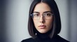 © UniDesign by Sonjib - A closeup portrait of a thoughtful young woman with dark hair and glasses