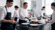 © Jana - Professional chef cooking with pans on stove while team of busy kitchen assistants and cooks work together in commercial restaurant kitchen during dinner service