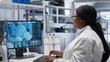 © DC Studio - African American woman researcher examines a compound in flasks and containers during laboratory testing, studying molecular content with biotechnology equipment for genetics research.