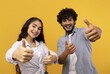 © Prostock-studio - Happy Young South Asian Male And Female Group Smiling And Giving Thumbs Up Gesture In Studio Setting With Bright Yellow Background. Expressing Joy And Positivity Together. Lifestyle Concept.