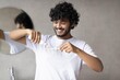 © Prostock-studio - Cheerful Young Male Adult Smiling While Brushing Teeth In Modern Bathroom, Focusing On Personal Care Routine. Enjoying Morning Hygiene In Indoor Setting, Promoting Healthy Lifestyle Concept.