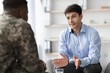 © Prostock-studio - Focused Conversation. Young White Male In Blue Shirt Talking With African American Male In Military Uniform At Office Setting, Engaging In Important Discussion About Work And Strategies.
