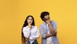 © Prostock-studio - Thoughtful Young Adults, One Male And One Female, Pondering Ideas With Curious Expressions, Standing Together Against A Bright Yellow Background, Deep In Thought, Concept Of Creativity And Ideas.