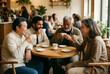 © Pixel-Shot - Diverse group of friends enjoying coffee and conversation in a cafe, social connection and community gathering