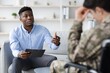 © Prostock-studio - Focused Black Male Therapist Engaging In Conversation With A Veteran In A Professional Office Setting, Discussing Mental Health Challenges And Counseling Options. Mental Health And Counseling Concept.