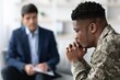© Prostock-studio - Worried Black Male Veteran Engaged In Conversation With Therapist In Professional Setting, Discussing Mental Health Challenges And Seeking Support, Sitting Comfortably In Office.