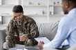 © Prostock-studio - Worried Young Caucasian Soldier Sitting On Sofa, Consulting Therapist In Professional Office, Discussing Emotional Health And Mental Wellbeing During Therapy Session. Healthcare Concept.