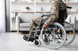 © Prostock-studio - Unrecognizable Black Male Soldier Relaxing In Wheelchair At Home, Embracing Calmness And Comfort In Cozy Living Room, Showcasing Resilience And Strength, Reflecting Healthcare Concept.