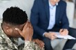 © Prostock-studio - Worried Black Male Soldier Experiencing Stress And Anxiety Discussing Mental Health With Counselor In Professional Office Setting, Seeking Support And Guidance. Addressing Mental Wellness Issues.