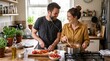 © Bruno Stock - Happy couple cooking together in a cozy kitchen sharing earbuds and laughing while preparing a healthy meal