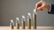 © Anhidrit'12 - Hand adding coin to increasing stacks inside glass tubes with glowing percentage and dollar signs, illustrating compound interest, savings growth, and financial investment strategy