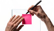 © Forhad - Person writing notes on a pink sticky note attached to a white board