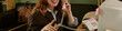 © AnnaStills - Header of young adult Caucasian woman smiling while talking on landline telephone in retro office. Image represents vintage corporate communication and nostalgic customer service