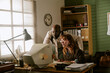 © AnnaStills - Diverse middle aged colleagues working on retro computer in vintage office, collaborating on project. Image suitable for corporate history campaigns or nostalgia marketing