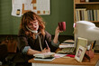 © AnnaStills - Young adult Caucasian woman working in retro office talking on landline telephone and writing notes. Image suitable for vintage corporate communication and nostalgic business marketing