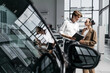 © wedmoments.stock - Salesperson and female customer talking beside a new car in a dealership during a consultation. Concept vehicle selection, automotive sales and customer service.