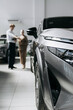 © wedmoments.stock - Vehicle in the foreground during a customer consultation in a dealership. Concept automotive sales and car selection.