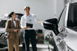 © wedmoments.stock - New vehicle displayed in a dealership during customer consultation. Concept vehicle sales and car selection.