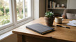© Mathew - Minimalist home office desk setup with a gray notebook potted succulent and coffee cup near a bright window view
