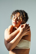 © LIGHTFIELD STUDIOS - Confident young african american woman embodies elegance and beauty in soft light