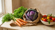 © Ibnu Fatah - Fresh carrots with green tops, leafy lettuce, red cabbage in a burlap bag, and colorful tomatoes rest on a beige table in warm daylight.