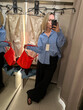 © Asya Molochkova/Stocksy - Woman Taking Mirror Selfie in Clothing Store Fitting Room