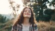© JPminimal - Happy young student enjoying a peaceful moment outdoors with eyes closed and a smile while surrounded by beautiful nature