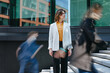 © Westend61 - Businesswoman standing still on stairs among blurred moving people