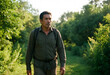 © Pixel-Shot - Adventure travel and outdoor exploration, mature man hiking with backpack on a forest trail during summer vacation in nature