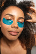 © Gonzalo Infiesta - Young woman enjoying self care with under eye patches