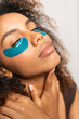 © Gonzalo Infiesta - Young woman enjoying under eye patch skincare routine
