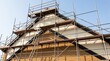© Btc - Scaffolding setup on a house facade during roof renovation and construction work