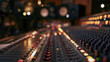 © valeo5 - Professional sound mixing console in modern audio recording studio with blurred background lights, warm sliders, buttons, faders, knobs, equalizer controls for music production and sound engineering