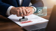 © MdAbul - Businessman stamping approved document with digital verification overlay interface