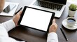 © BrilliantPixels - Man's hands holding a digital tablet computer with an isolated white screen on a wooden desk.