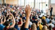 © BrilliantPixels - A person is raising hands for participation in a large crowd.