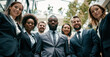 © Surachetsh - A diverse group of smiling professionals poses together for a corporate photo that emphasizes unity, teamwork, and professional success in a business environment.