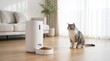 © Tonton1541 - digital pet food timer concept. Cat waiting for food from an automatic pet feeder in a modern living room.