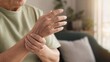 © Hala - Senior person holding painful wrist at home, arthritis and joint pain in older adult