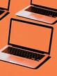 © The Little Hut - Modern Laptops Arranged on Vibrant Orange Background for Digital Technology Concepts