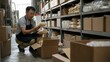 © fotogurme - middle aged asian man wearing black apron, worker packing food products into cardboard boxes, warehouse storage with industrial shelves