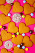 © Taigi - Top view of candies and heart shaped cookies on a vibrant pink background. Dessert photography, sweet treats.