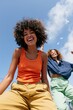 © Andrii Zastrozhnov - Joyful young women running and laughing under a clear blue sky with doves, vibrant summer lifestyle image for marketing and lifestyle use