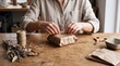 © Chainarong - Artisan Hands Wrapping a Sustainable Gift Package with Rustic Brown Paper and Twine in a Bright Minimalist Handmade Craft Workshop