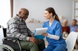 © Prostock-studio - Focused Caring White Female Nurse Assisting Elderly Black Man In Wheelchair While Reviewing Medical Information, In Modern Healthcare Clinic Setting. Healthcare Concept.