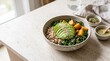 © MUBI - Healthy buddha bowl with avocado, kale, and grains on a stone kitchen counter.